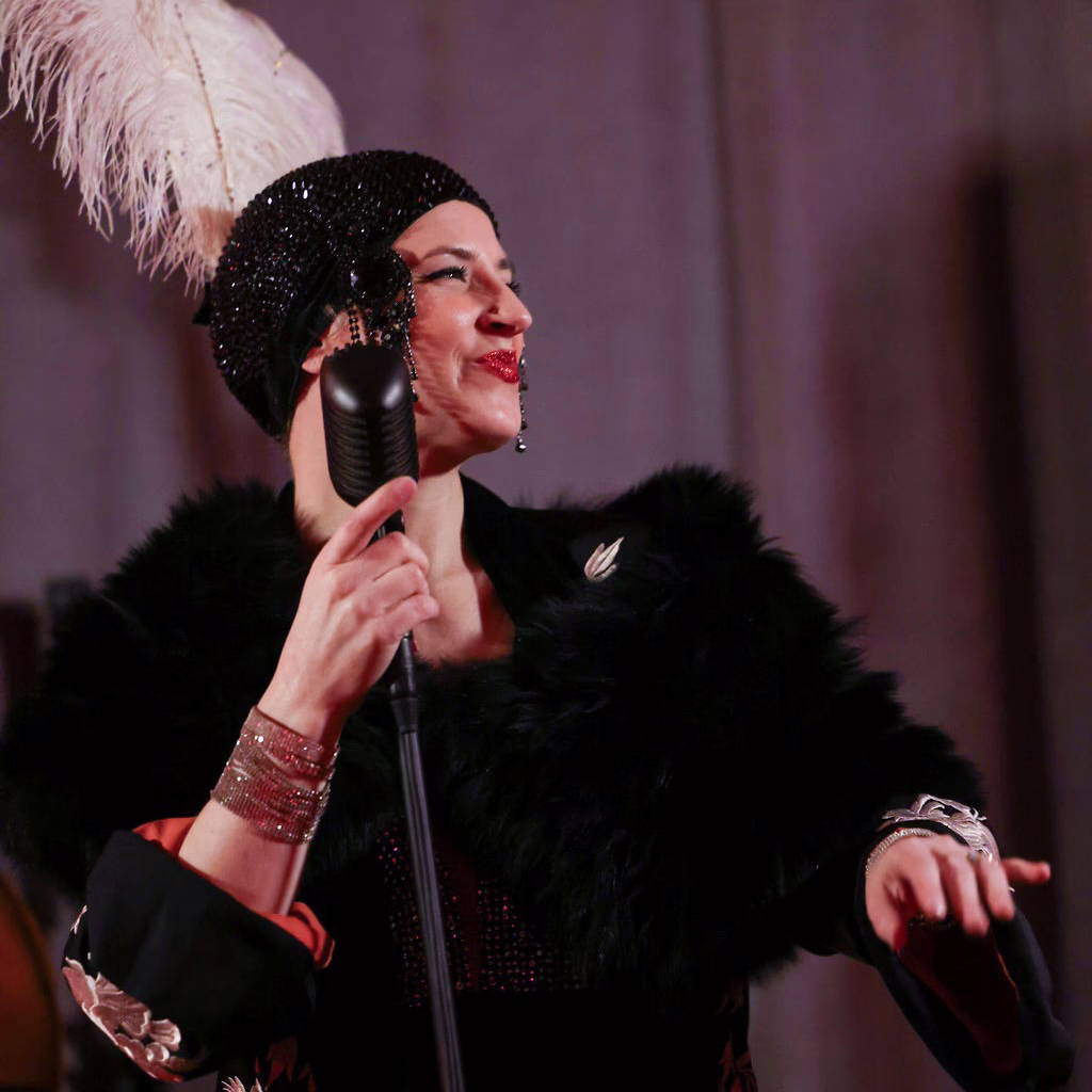 Acoustic ensemble singer in glamorous 1920s-inspired outfit